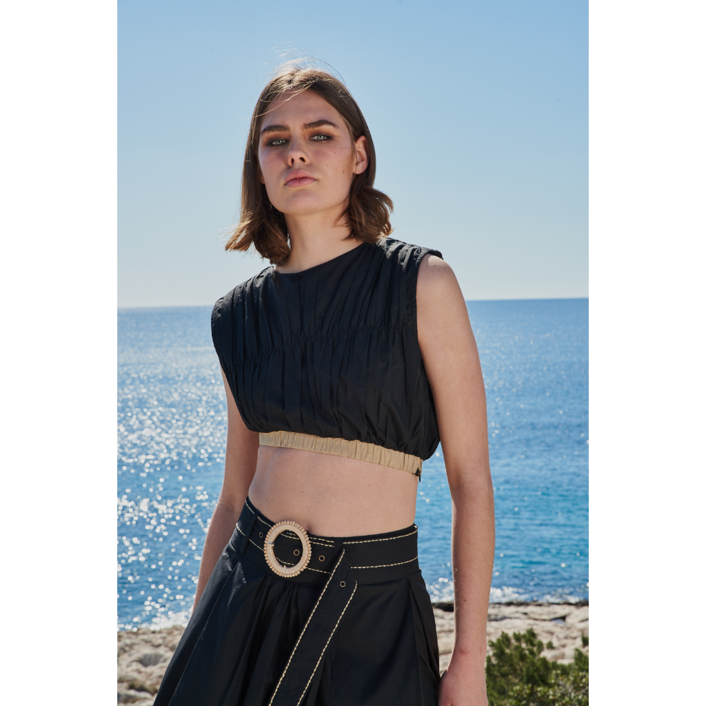 Trishala Sikka in Black poplin asymetrical skirt with chawal taka hemline and belt paired with ruched crop top
