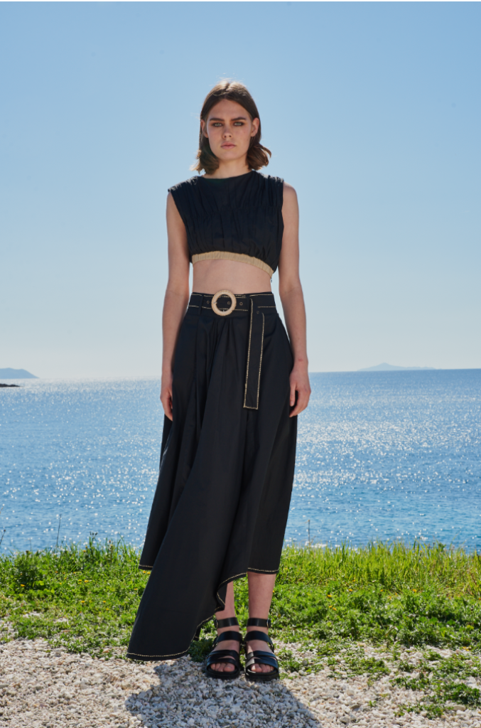 Trishala Sikka in Black poplin asymetrical skirt with chawal taka hemline and belt paired with ruched crop top