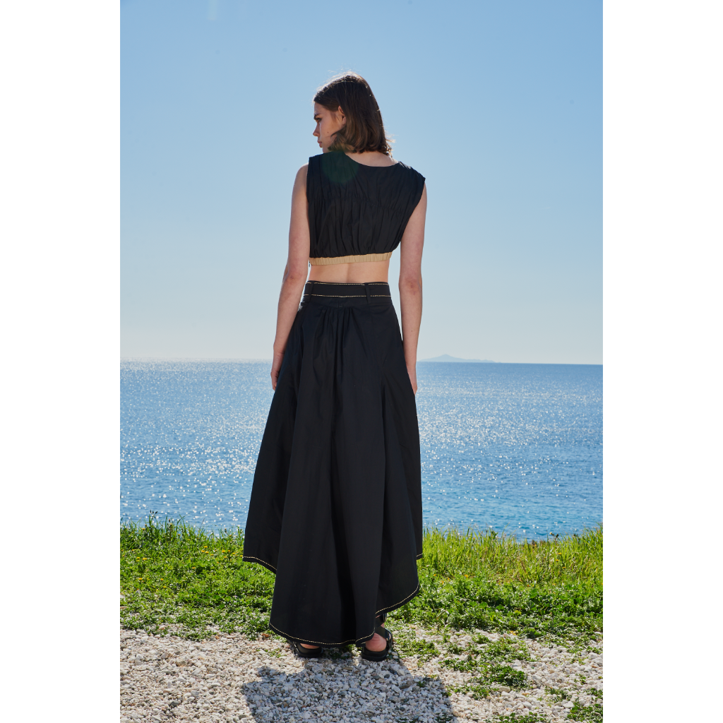 Trishala Sikka in Black poplin asymetrical skirt with chawal taka hemline and belt paired with ruched crop top