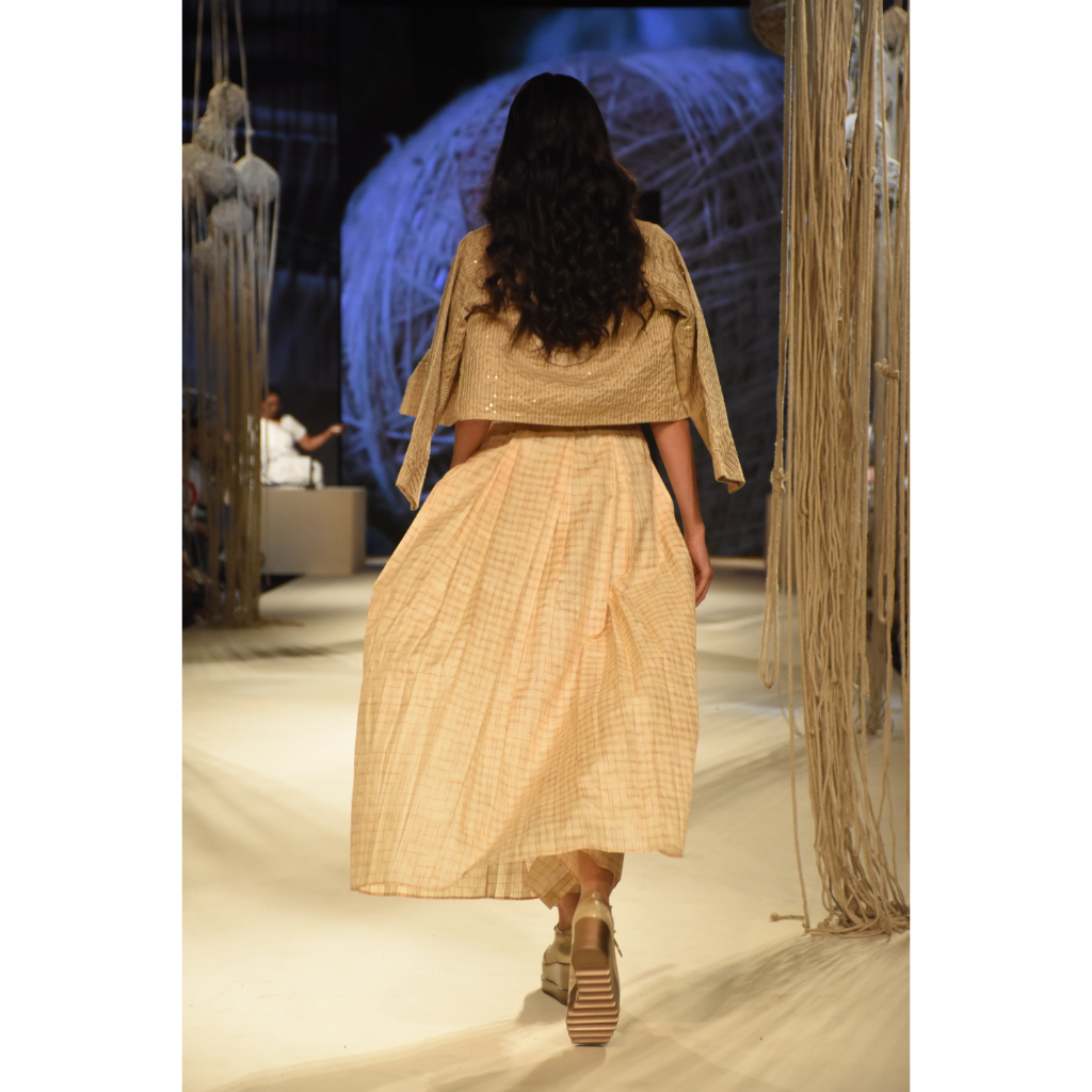 Beige embroidered crop jacket with bustier, beige shorts and front open 3 pleated skirt