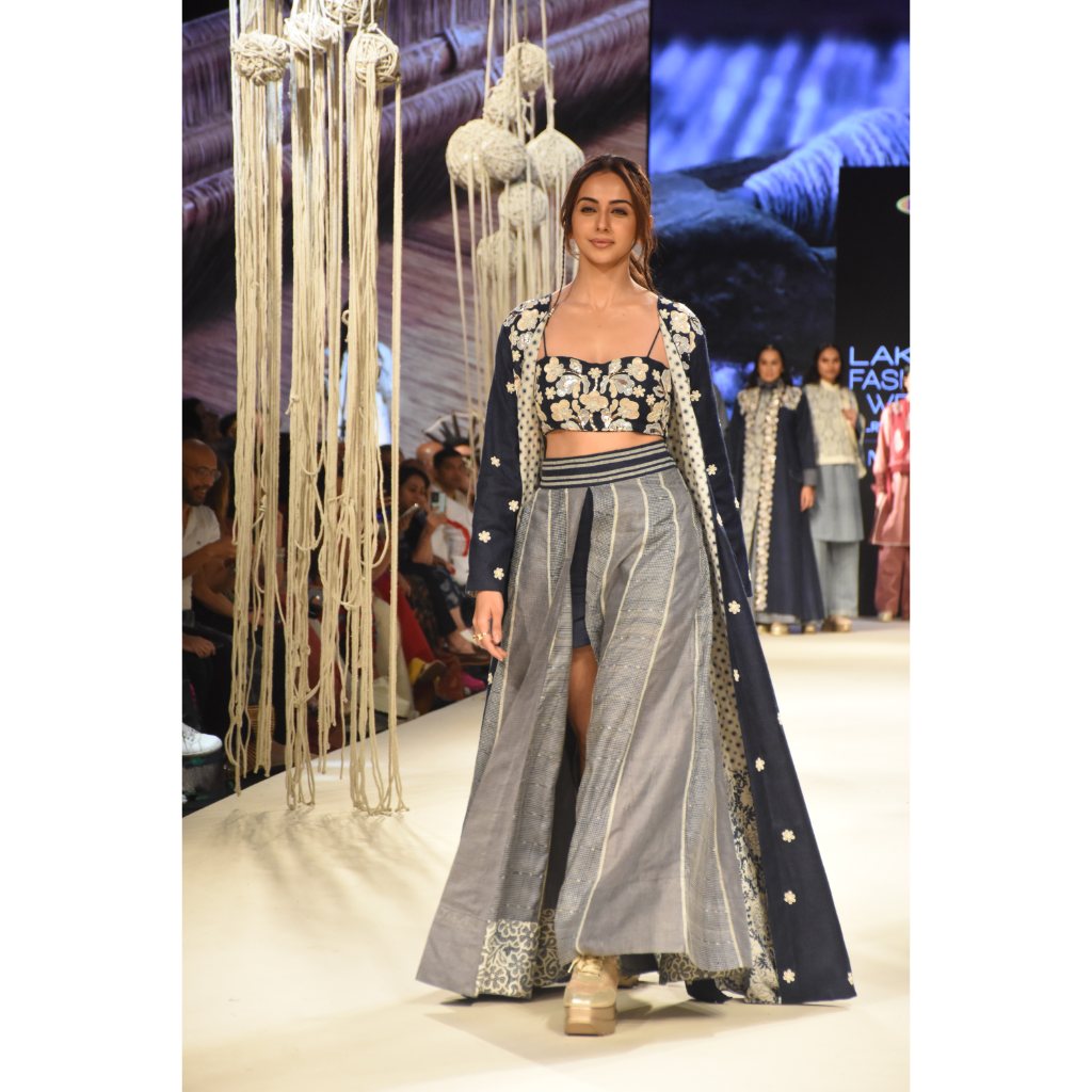 Blue embroidered long jacket with a front open checked kalidar skirt and an attached shorts with embroidered bustier
