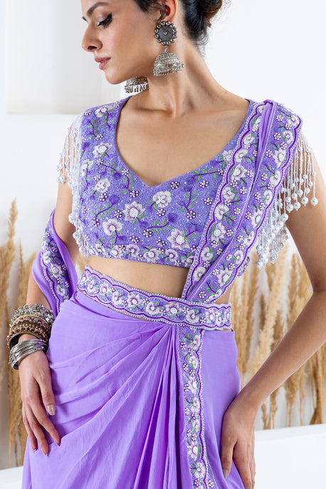 Lilac pearl crepe draped saree with embroidered border, blouse and waist belt