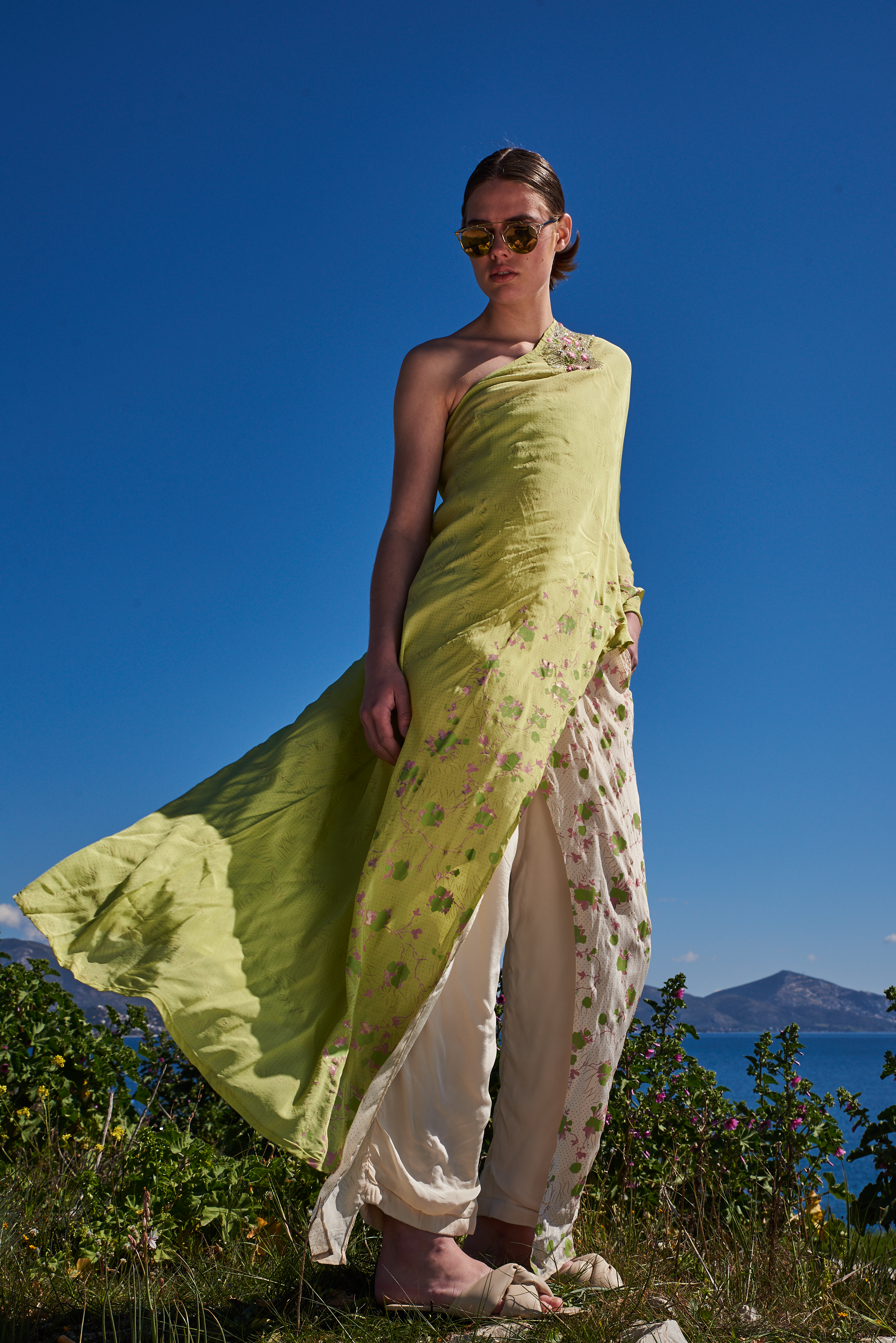 Green crepe printed and embroidered asymmetrical one off shoulder cape with ivory printed flap pants