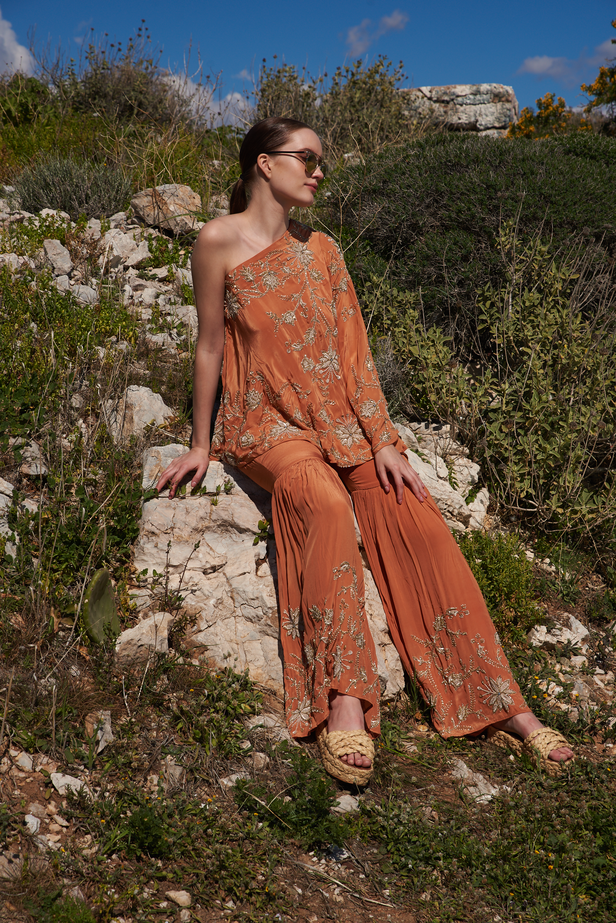 Rust crepe embroidered one off shoulder cape with rust crepe embroidered sharara pants