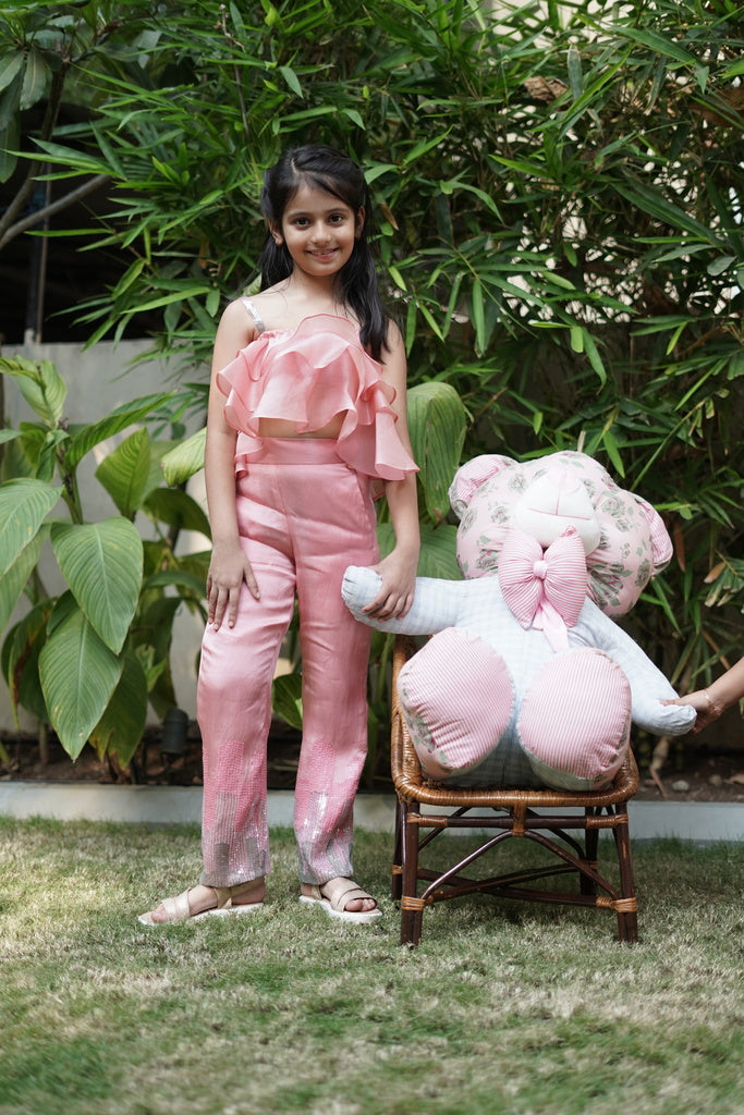 Pink ruffle top with embroidered pants