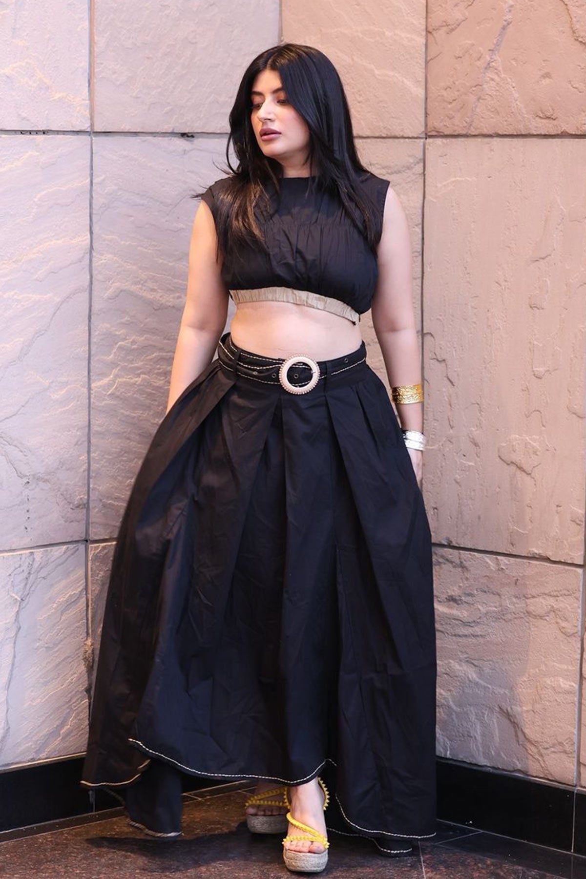 Trishala Sikka in Black poplin asymetrical skirt with chawal taka hemline and belt paired with ruched crop top