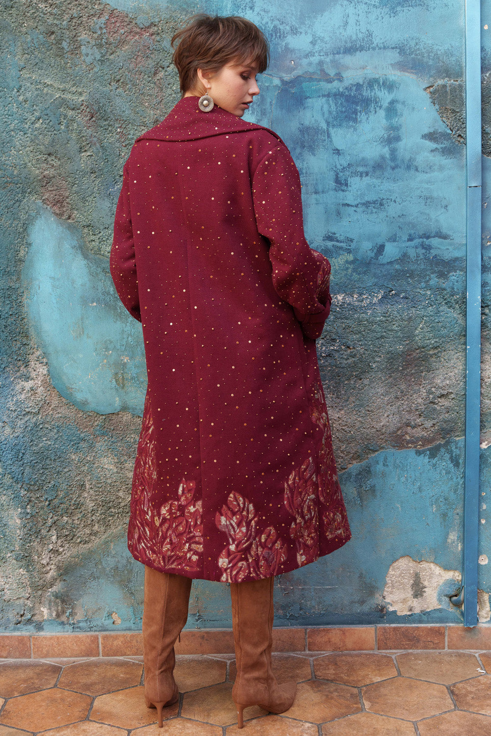 Red embroidered trench with printed appliqué.