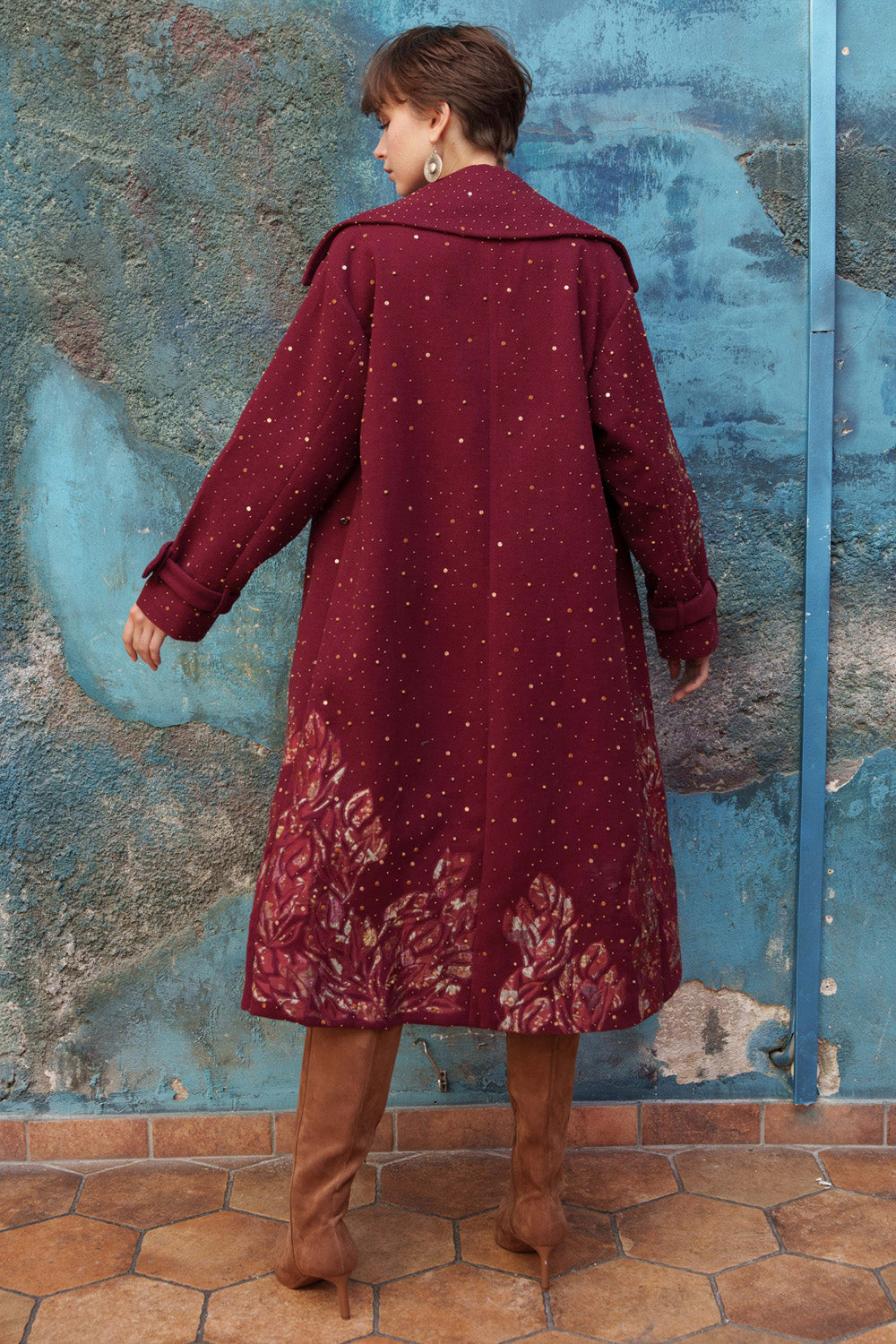 Red embroidered trench with printed appliqué.