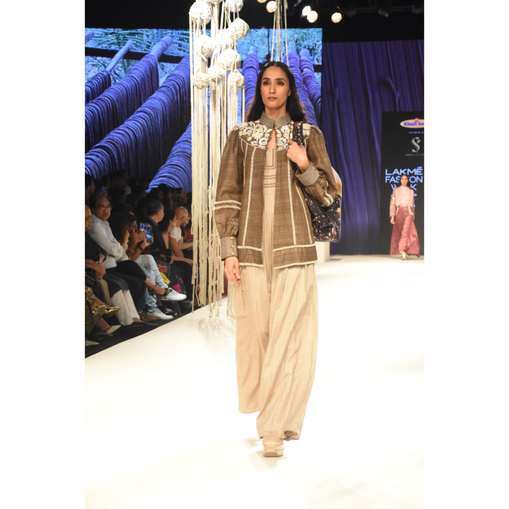 Brown khadi jacket with embroidered yoke and stripe jumpsuit with stitchline detais on bodice