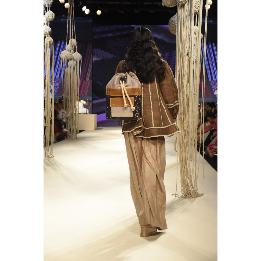 Brown khadi jacket with embroidered yoke and stripe jumpsuit with stitchline detais on bodice