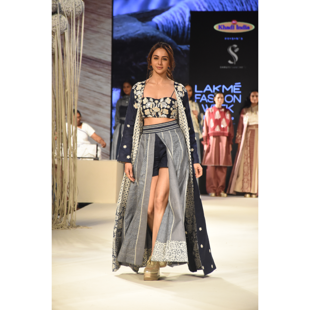 Blue embroidered long jacket with a front open checked kalidar skirt and an attached shorts with embroidered bustier