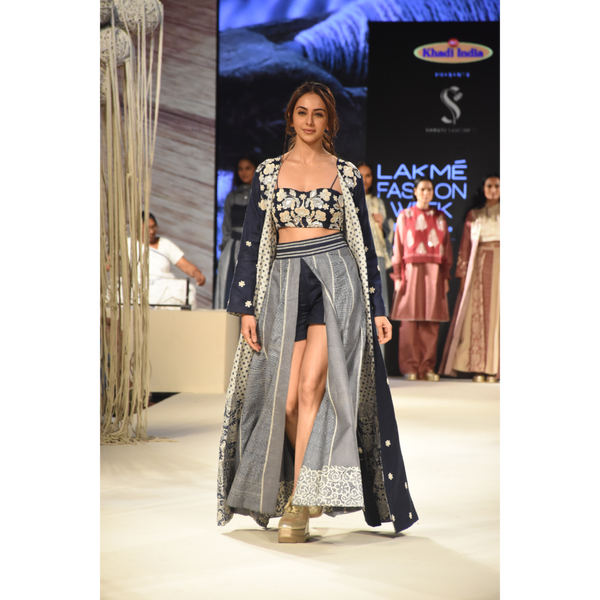 Blue embroidered long jacket with a front open checked kalidar skirt and an attached shorts with embroidered bustier