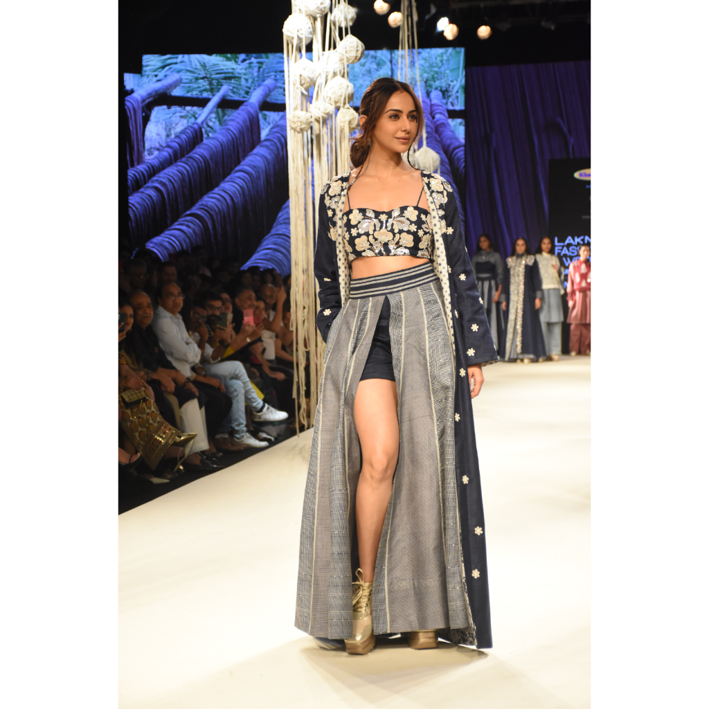 Blue embroidered long jacket with a front open checked kalidar skirt and an attached shorts with embroidered bustier