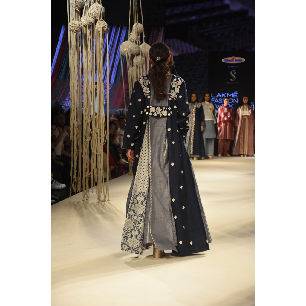 Blue embroidered long jacket with a front open checked kalidar skirt and an attached shorts with embroidered bustier